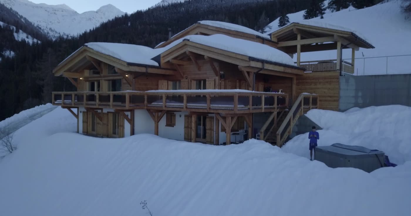 Timber mountain home with a snow-covered roof